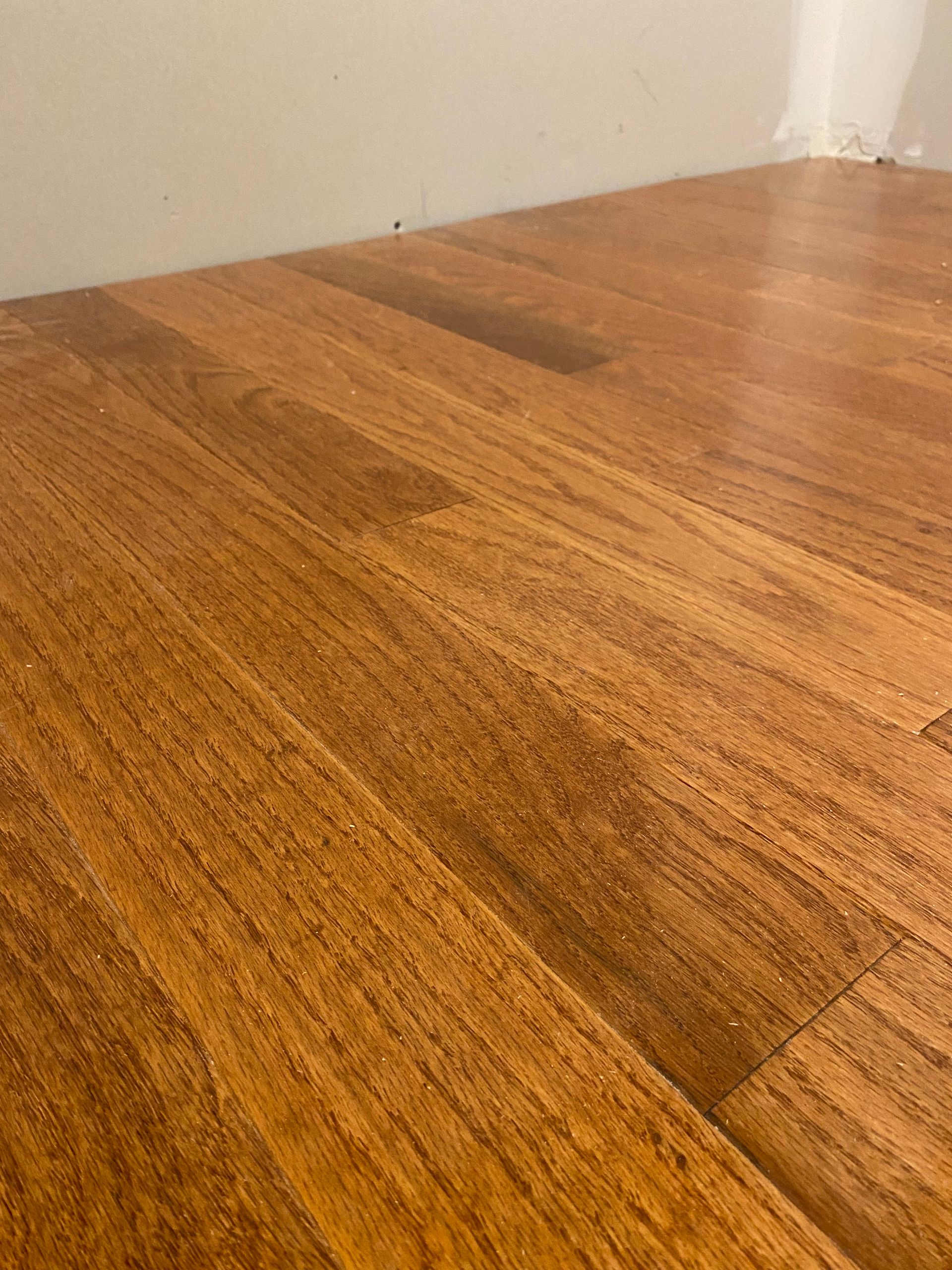 A close up of a wooden floor in a room.