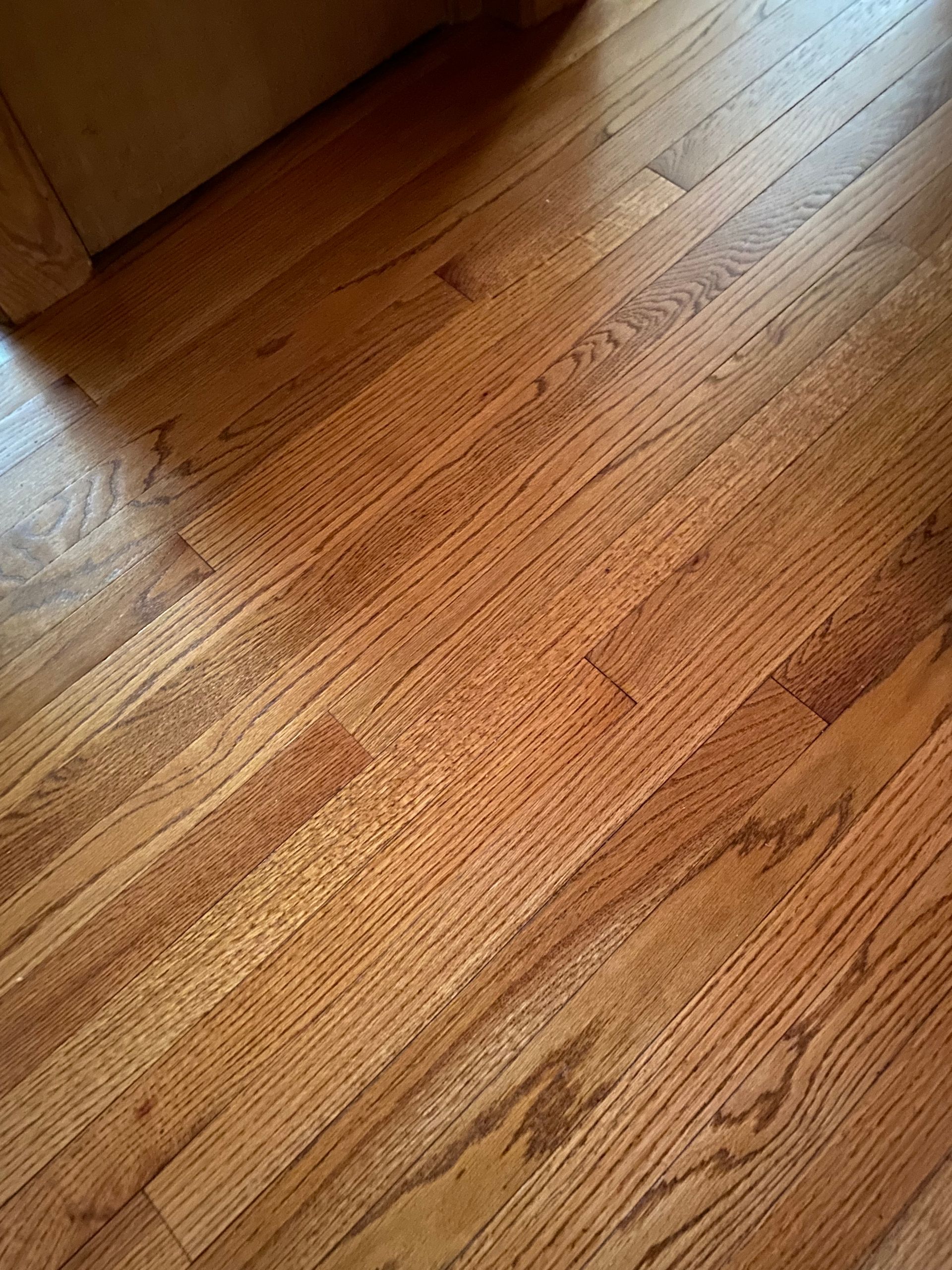 A close up of a wooden floor in a room.