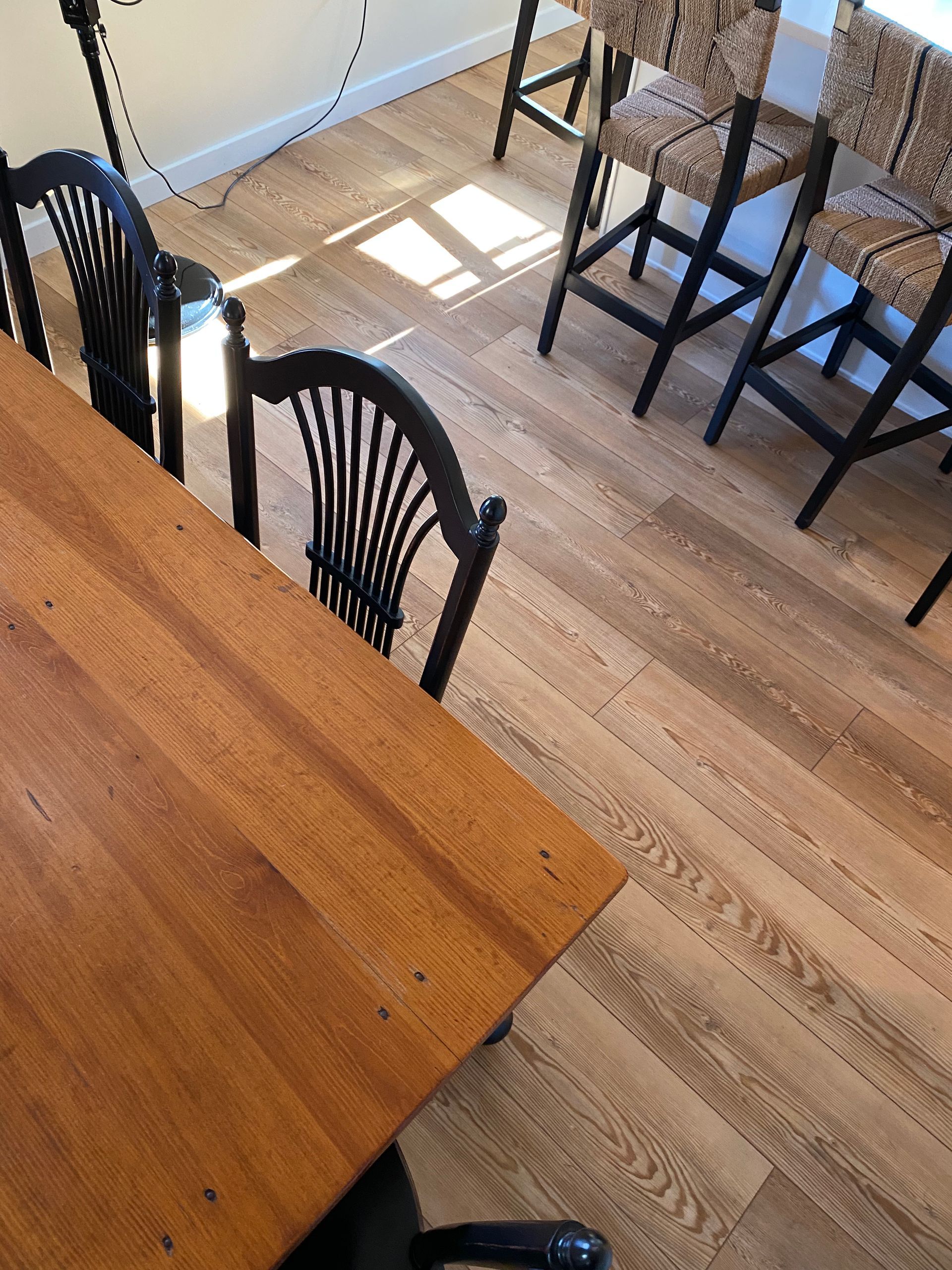A wooden table and chairs in a room with hardwood floors