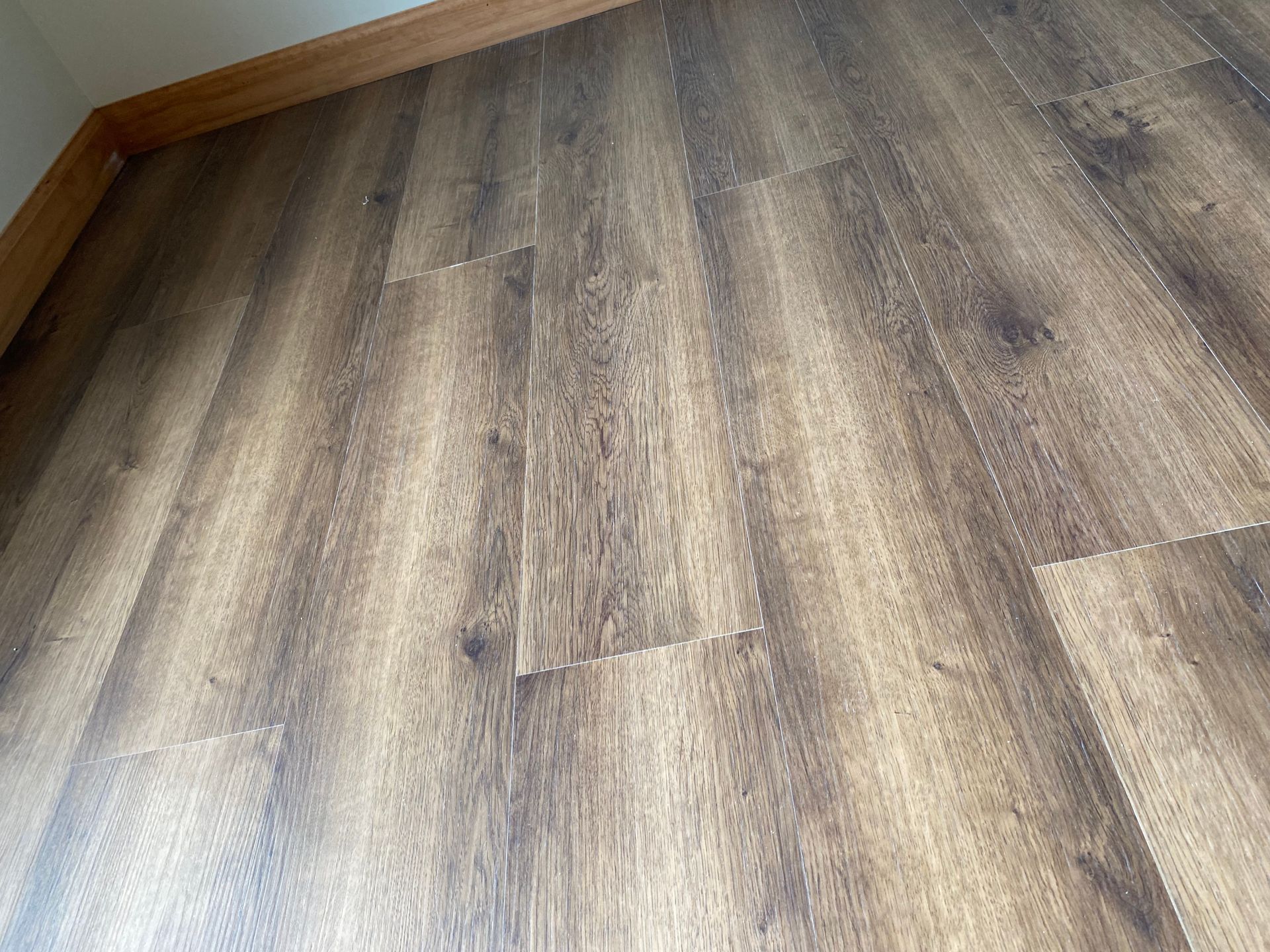 A close up of a wooden floor in a room.