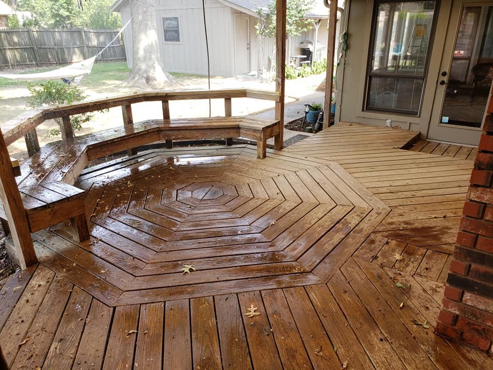 A wooden deck with a bench in the middle of it.