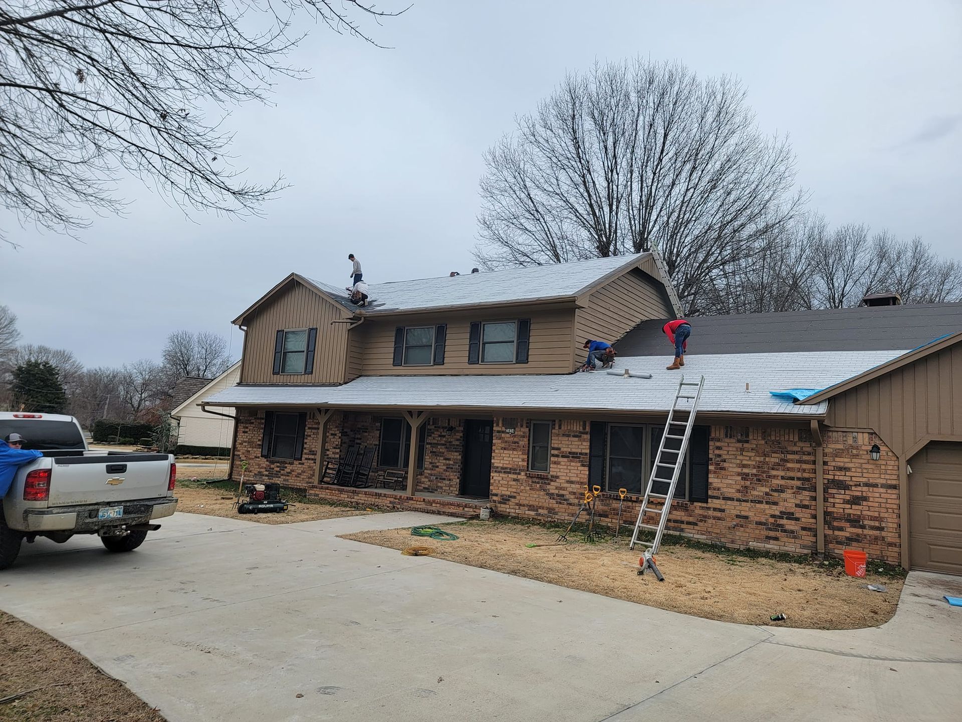 A truck is parked in front of a house that is being remodeled.