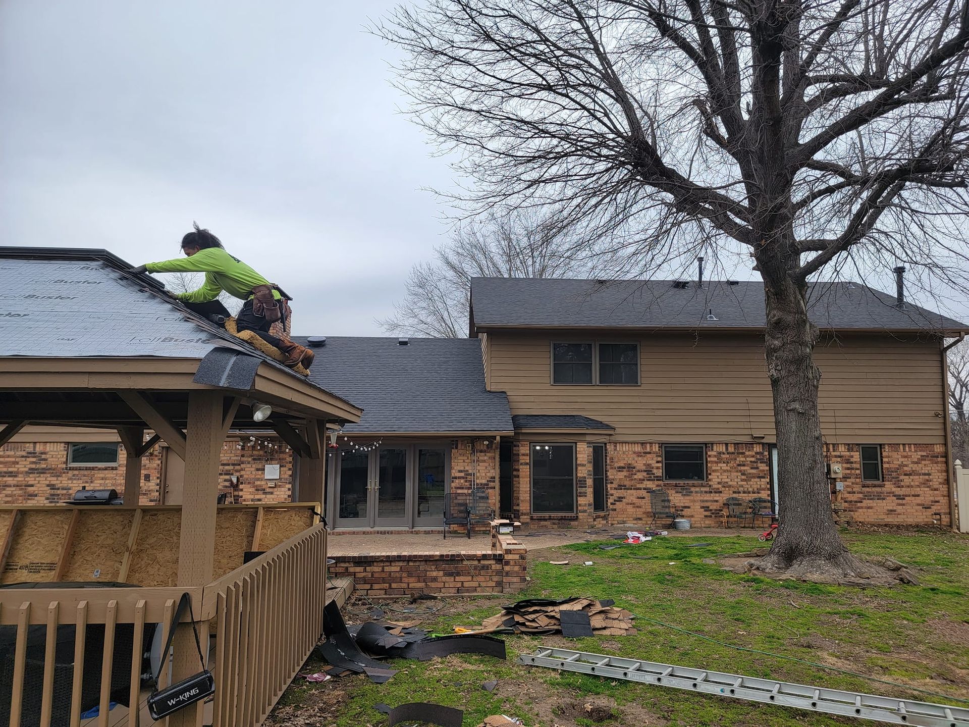 A man is working on the roof of a house.