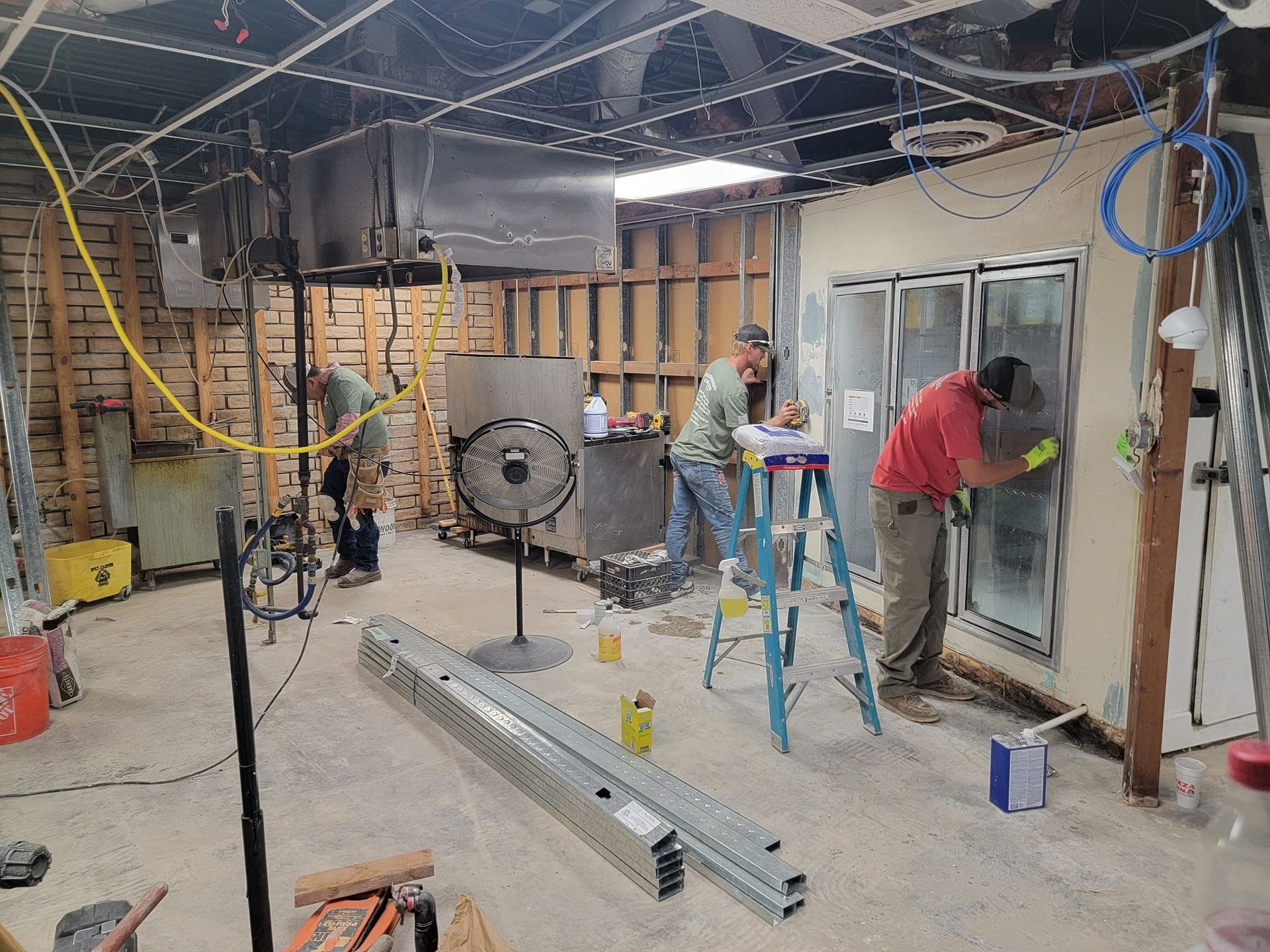 A group of men are working on a building in a basement.