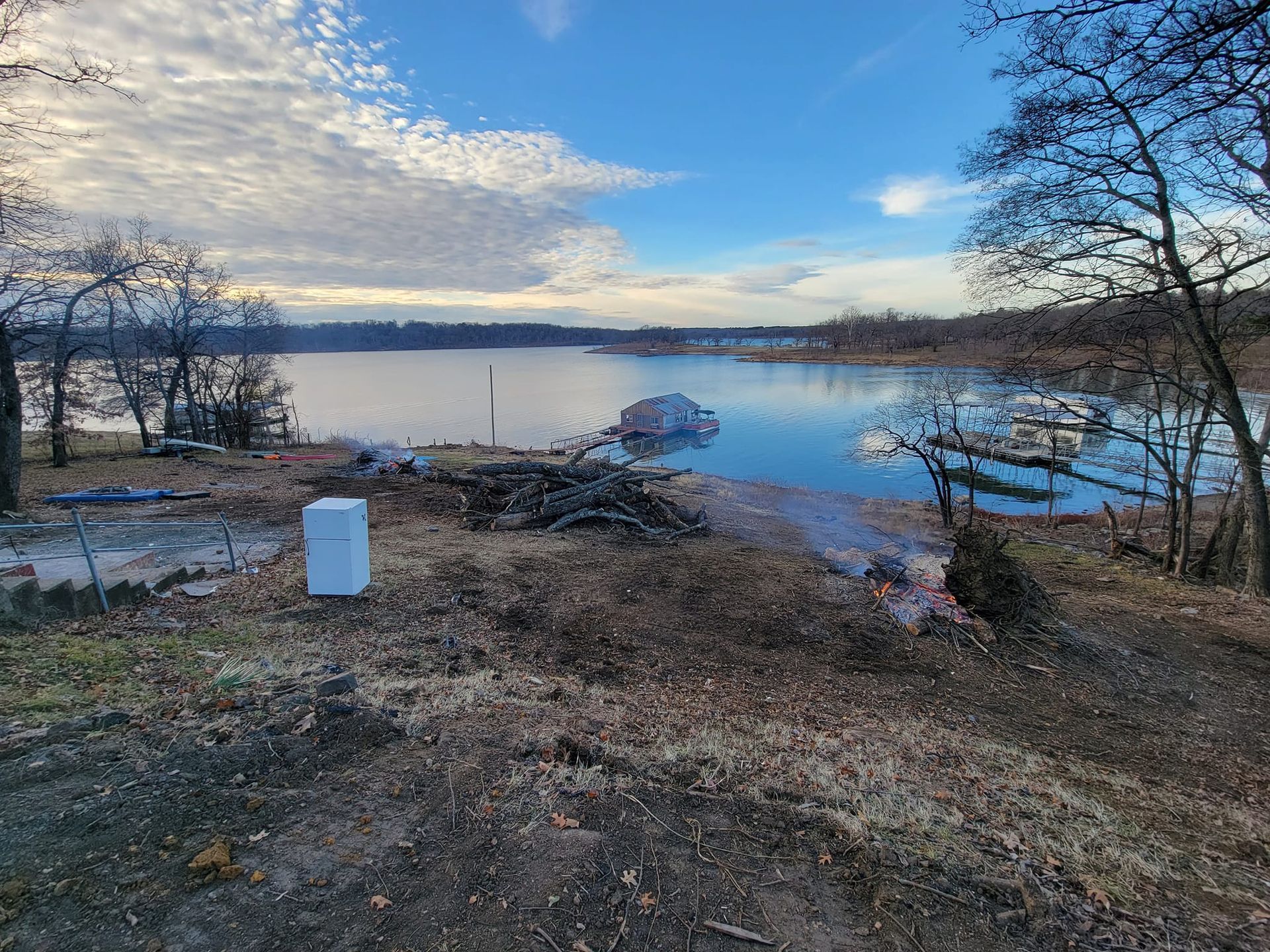 A large body of water surrounded by trees on a sunny day.