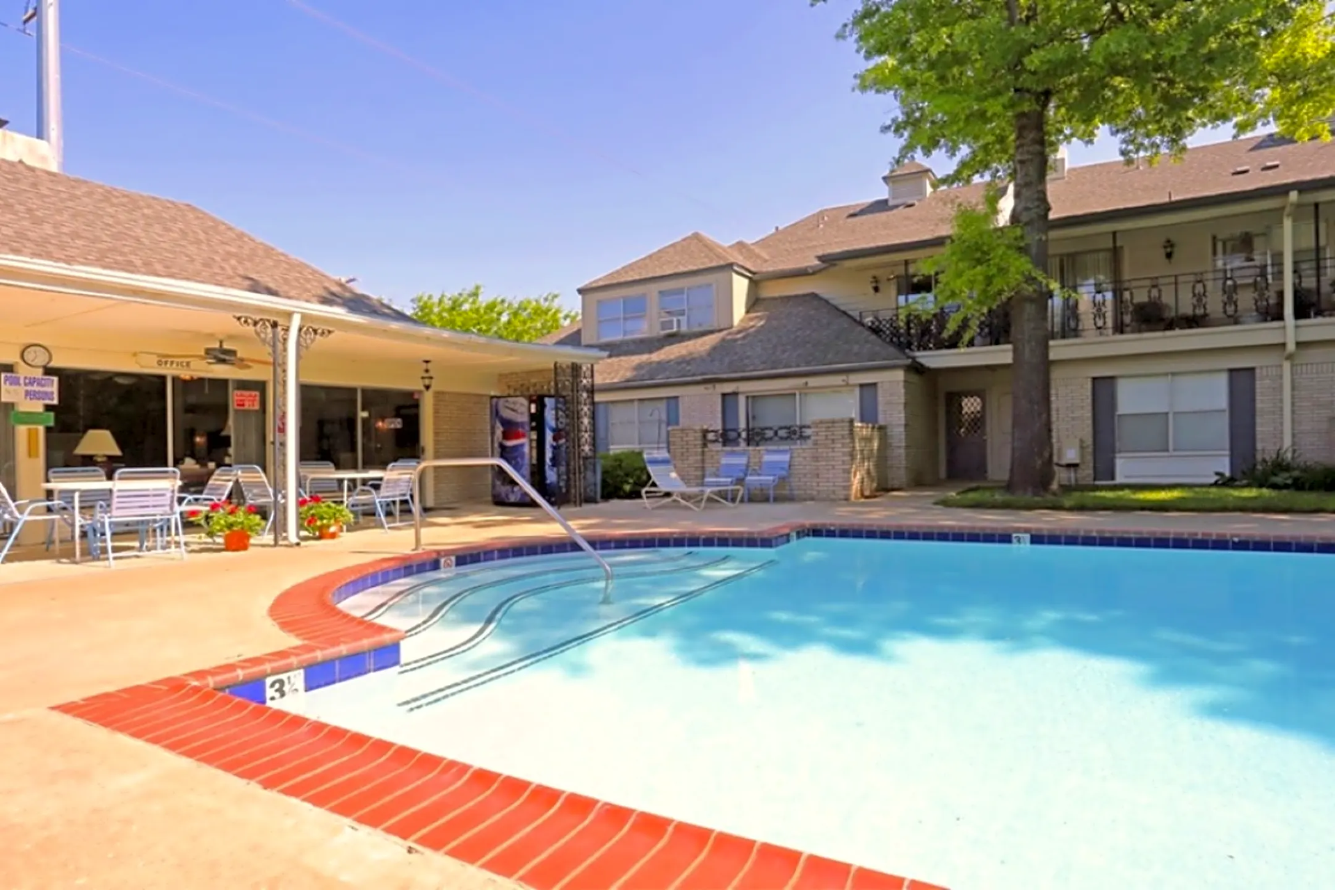 Pool Photo with apartments in view and steps showing