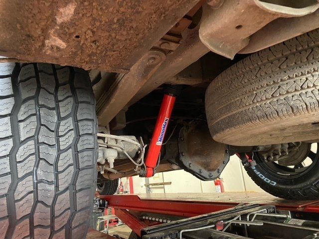 A red shock absorber installed under a car