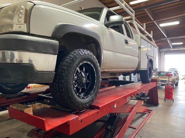 A truck on a lift undergoing maintenance -  JCR Performance, your Trusted Auto Repair Shop in Sacramento, CA