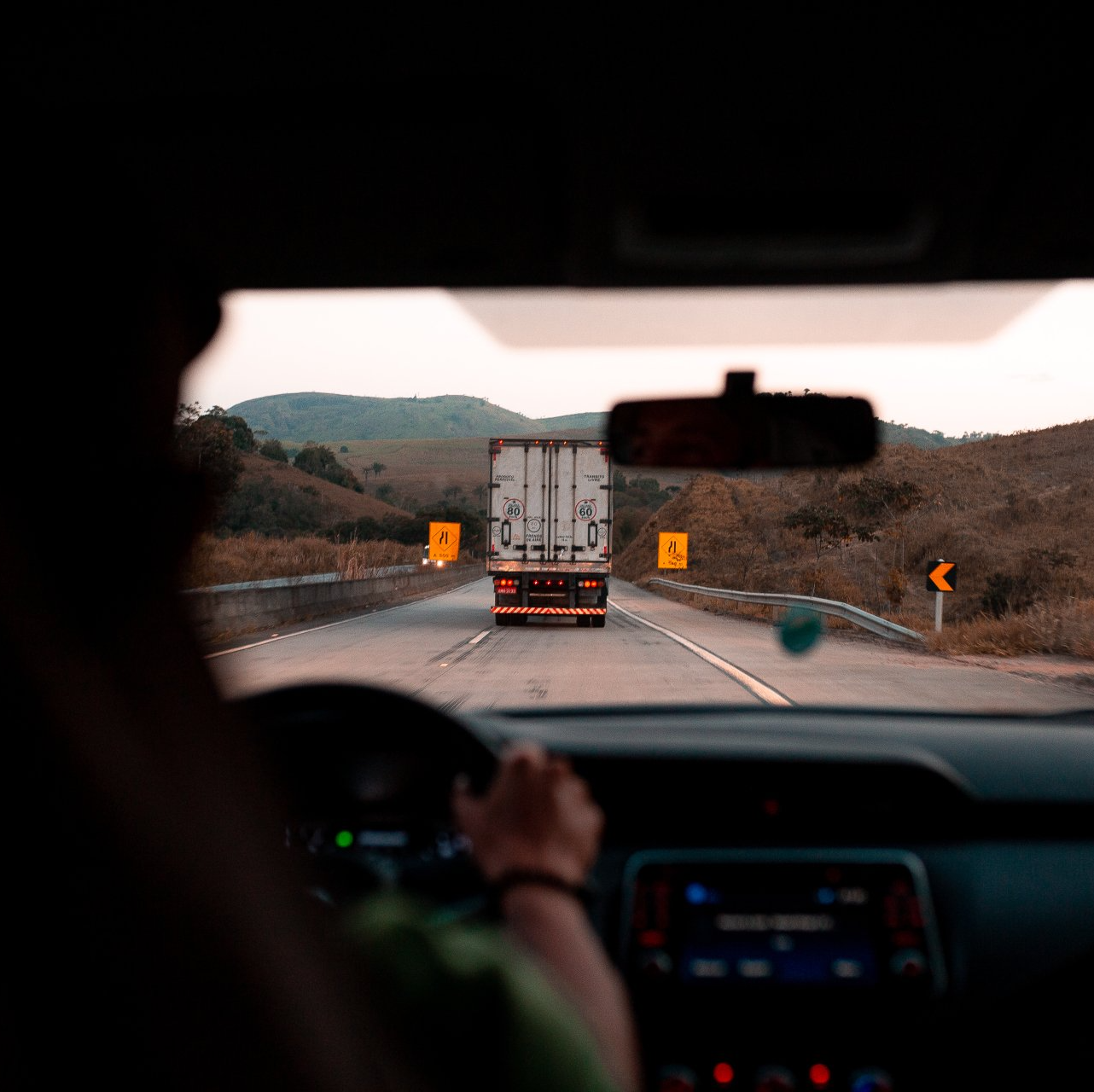 A person driving a truck down a highway