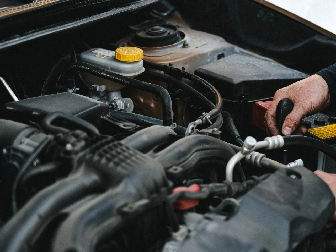 A person working on the engine of a car | Partner wit JCR Performance for Auto & Car Engine Repairs in Sacramento, CA