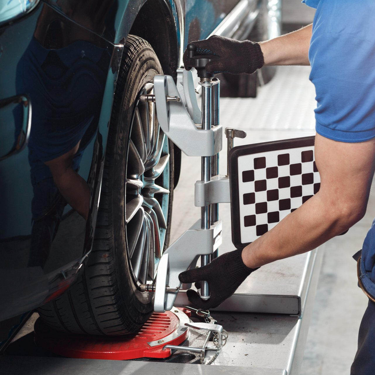 A mechanic performing a wheel alignment repair | Best Tire Repair Shop in Sacramento, CA - JCR Performance