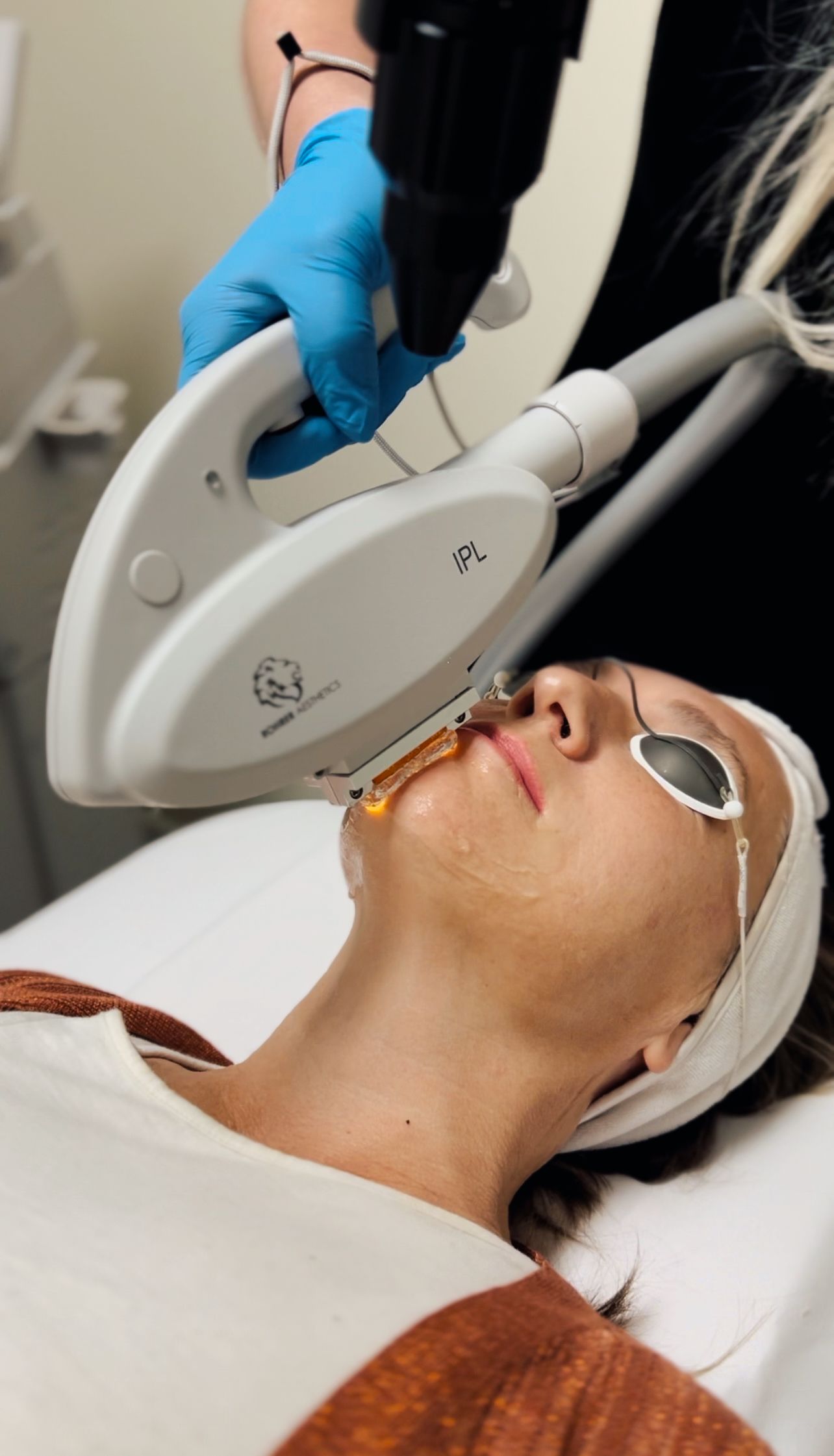 Licensed master esthetician performing a medical-grade Spectrum IPL photofacial near Syracuse, UT