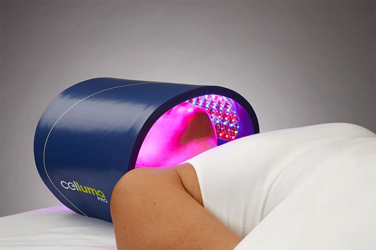 Person undergoing red light therapy with a blue device over their face.