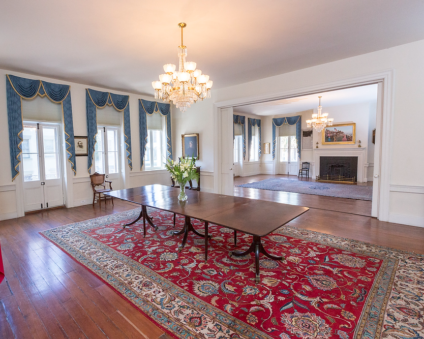 A large room with a table and a rug