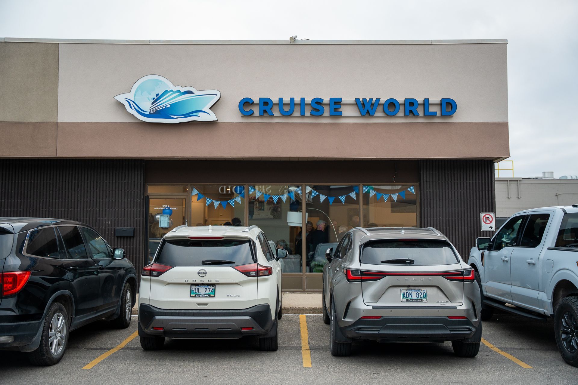 Cruise World storefront with parked cars and SUVs in front
