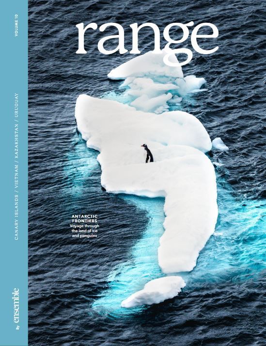 Magazine cover with a lone person on a white iceberg in dark blue ocean, titled “range”