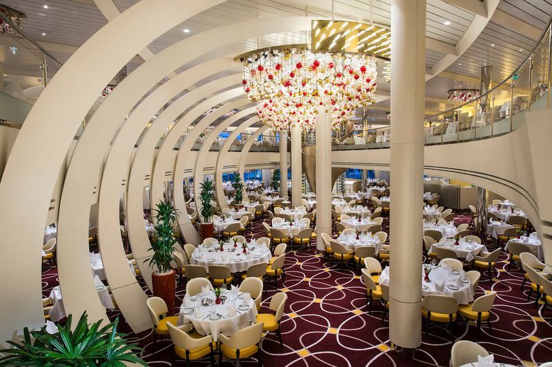 dining room A large dining room with tables and chairs and a large chandelier.