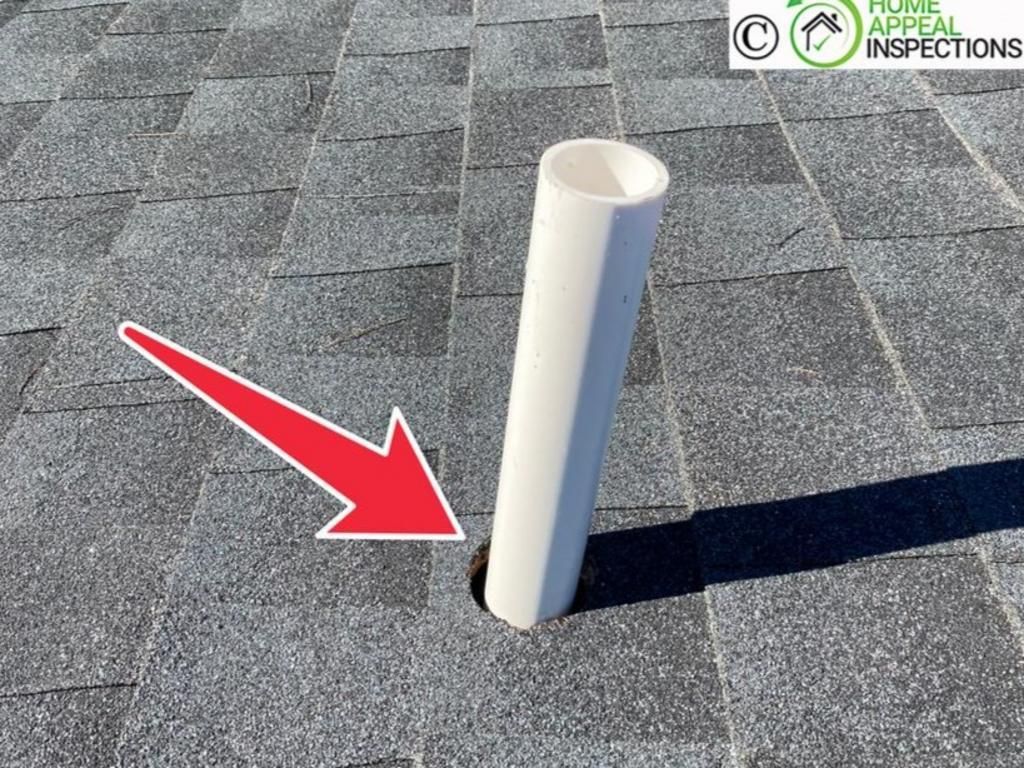 A white plumbing vent pipe protrudes through gray asphalt roof shingles with a red arrow pointing to a gap at the base.