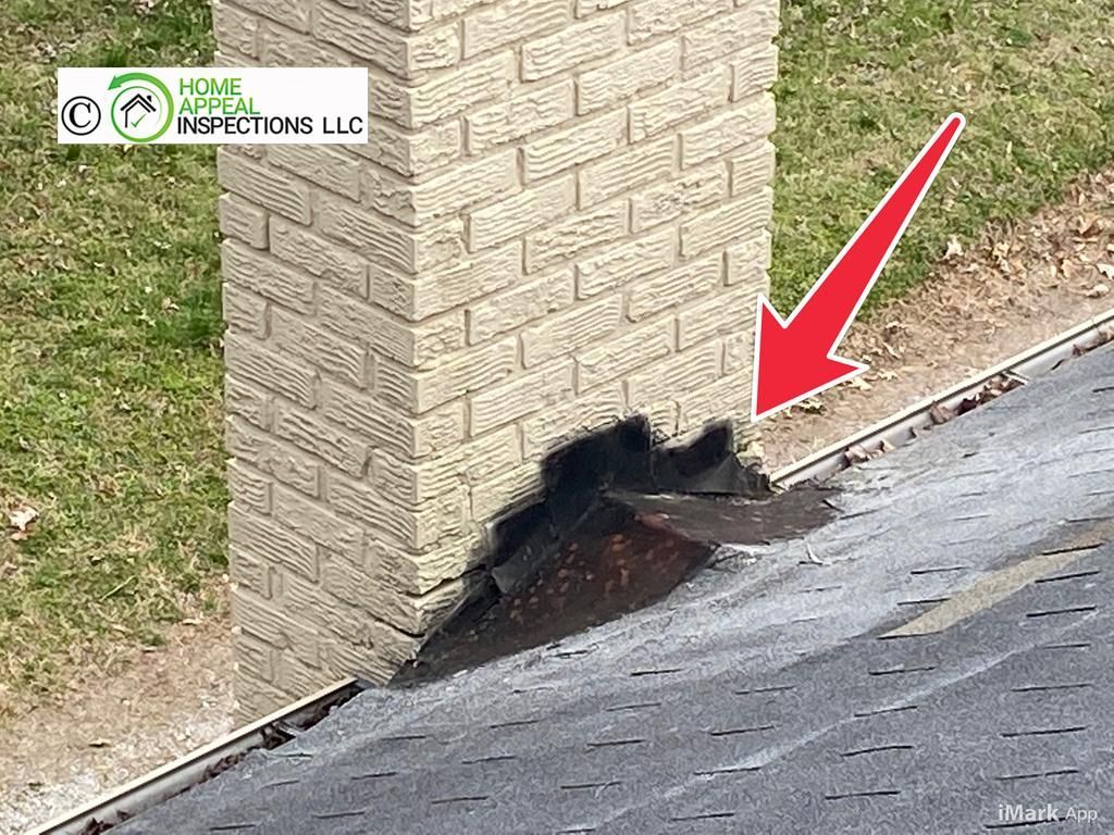 A red arrow points to a damaged, improperly sealed roof flashing where it meets a brick chimney.