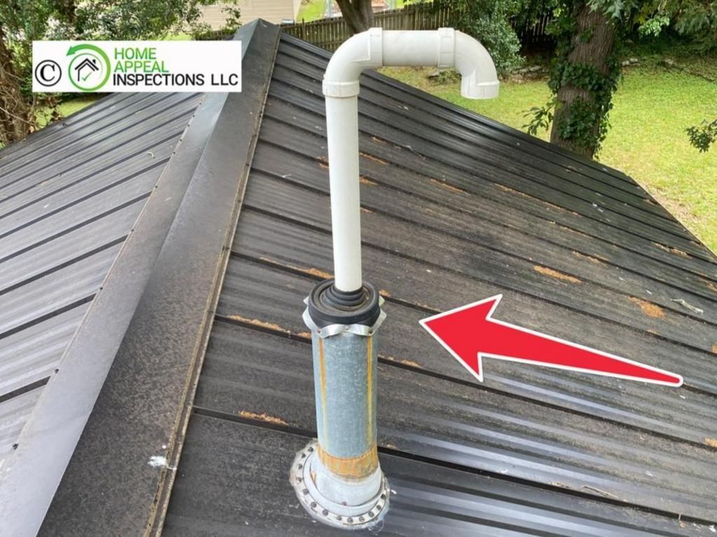 A red arrow points to a white PVC vent pipe protruding from a metal roof through a galvanized flashing collar.