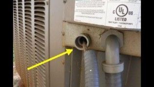 A yellow arrow points to an open conduit hole on an outdoor HVAC unit, exposing wiring that lacks a protective connector.