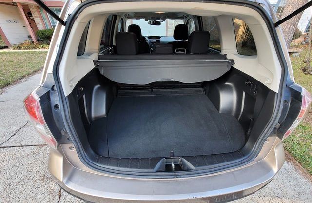 Open car trunk with empty cargo area and beige interior trim