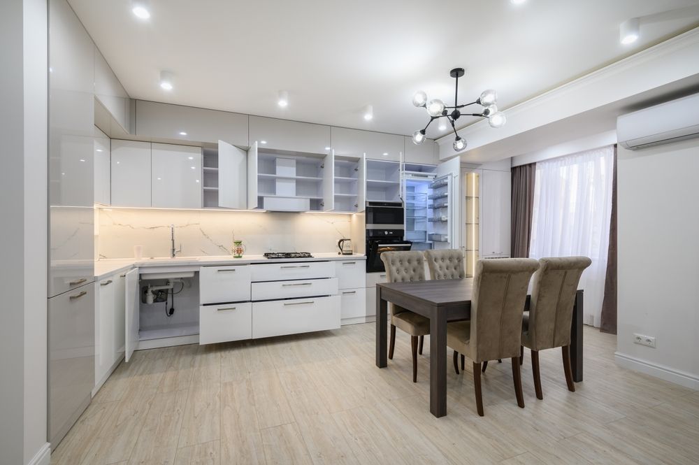 A kitchen with a table and chairs in it