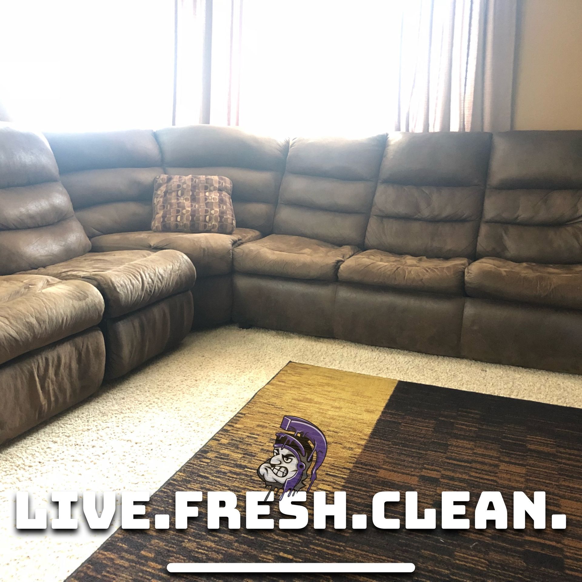 Brown sectional sofa and rug in a room with the text 
