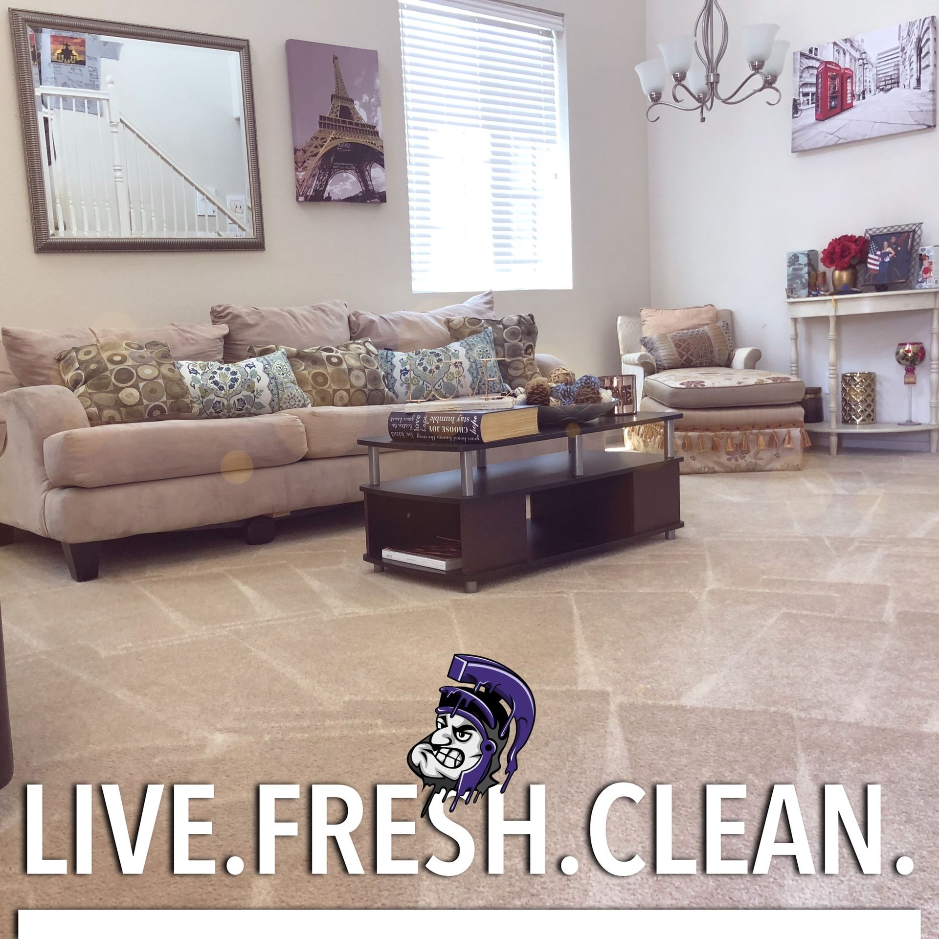 Living room with beige couch, carpet, and decorative art. 