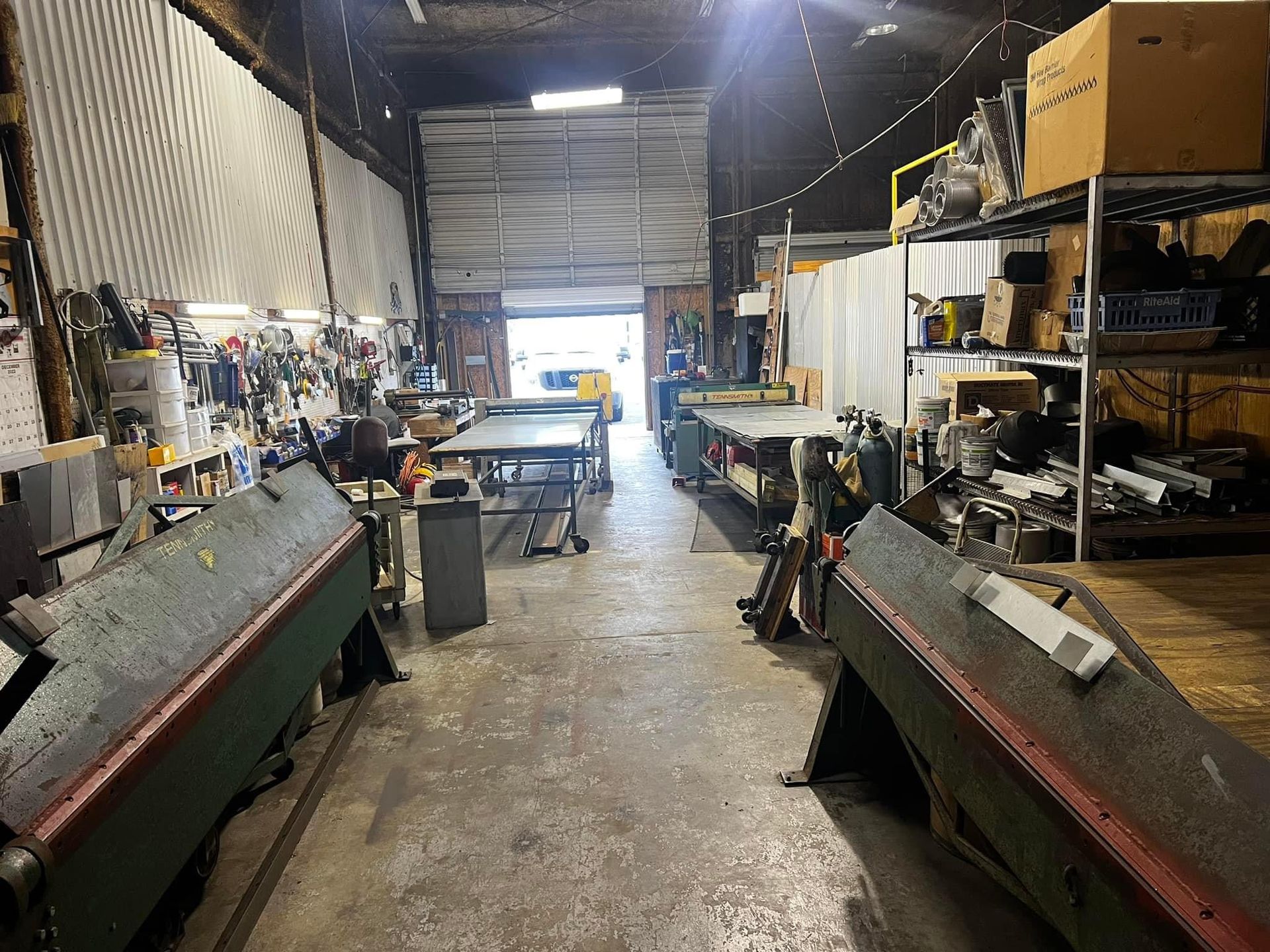 A large warehouse filled with lots of machinery and tools.