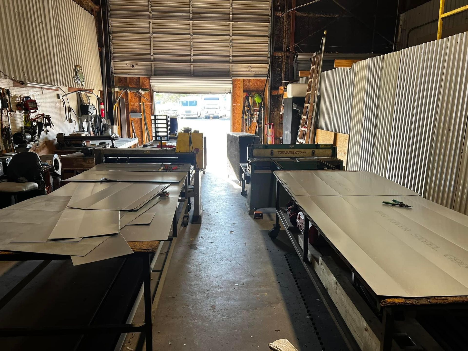 A warehouse with lots of tables and a garage door