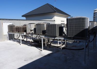 A rooftop with a lot of air conditioners on it