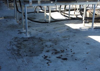 A dirty floor with a lot of wires on it