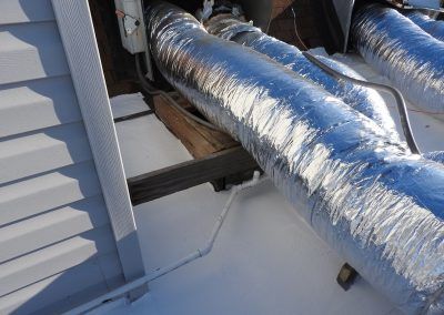 A close up of a duct on the side of a building.