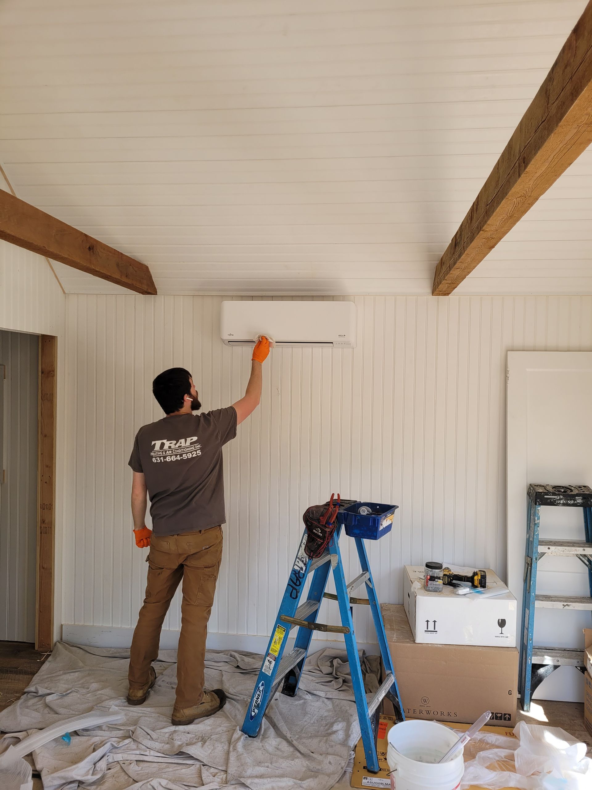 man fixing AC unit