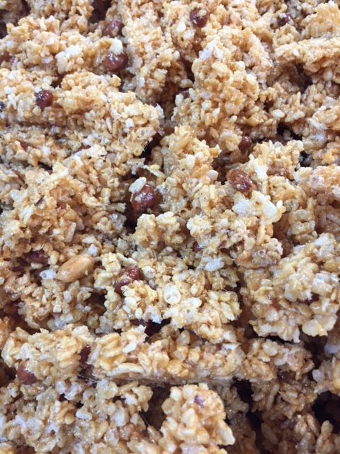 A close up of a pile of food with rice and nuts