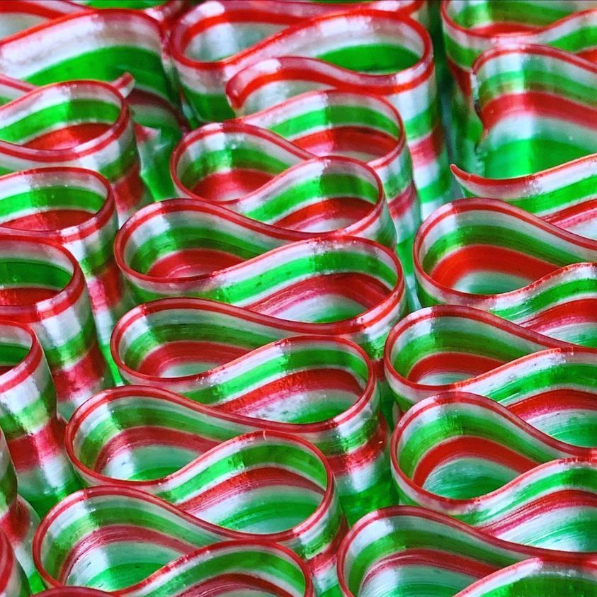 A close up of red , white and green striped candy canes.