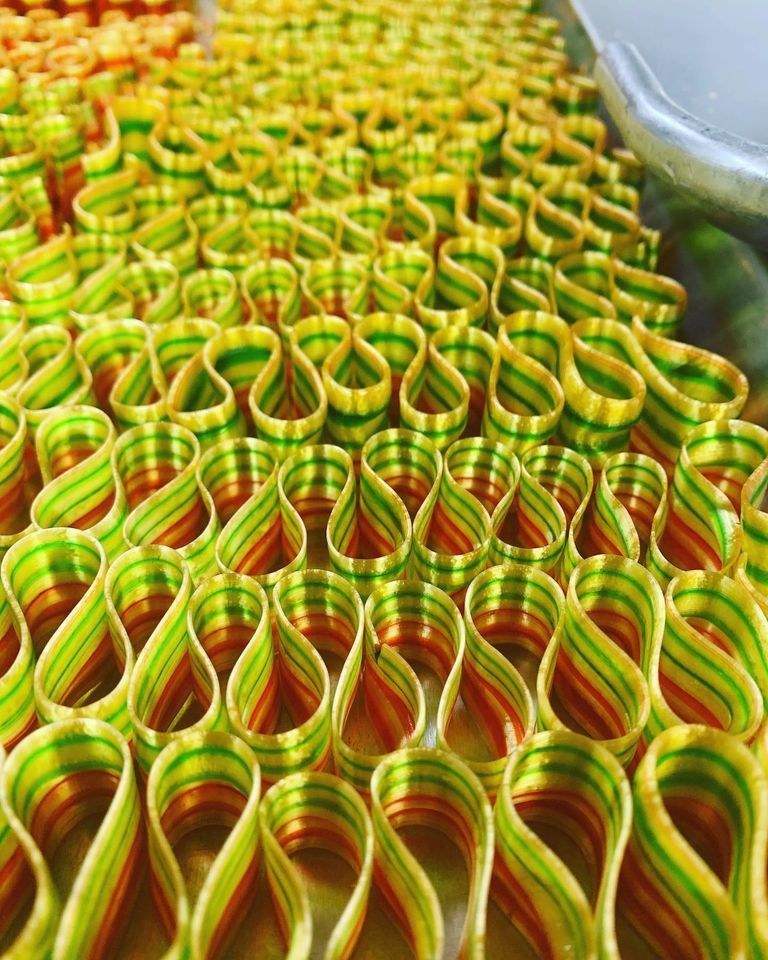 A bunch of colorful ribbons are lined up on a table.