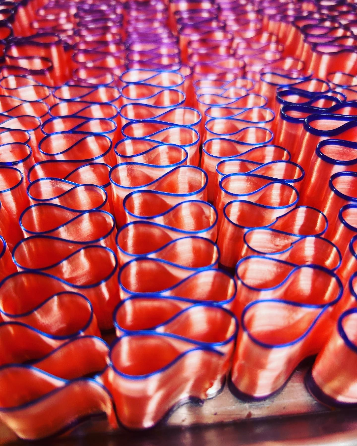A bunch of red cups with blue rims on a table