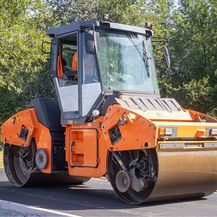smooth drum roller going down a newly asphalted road