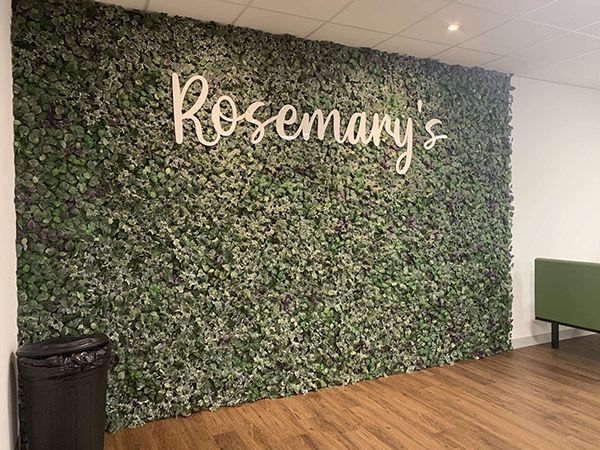 A green wall with the word rosemary written on it.
