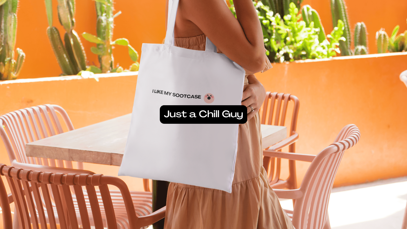 A woman is holding a white tote bag that says just a chill guy.