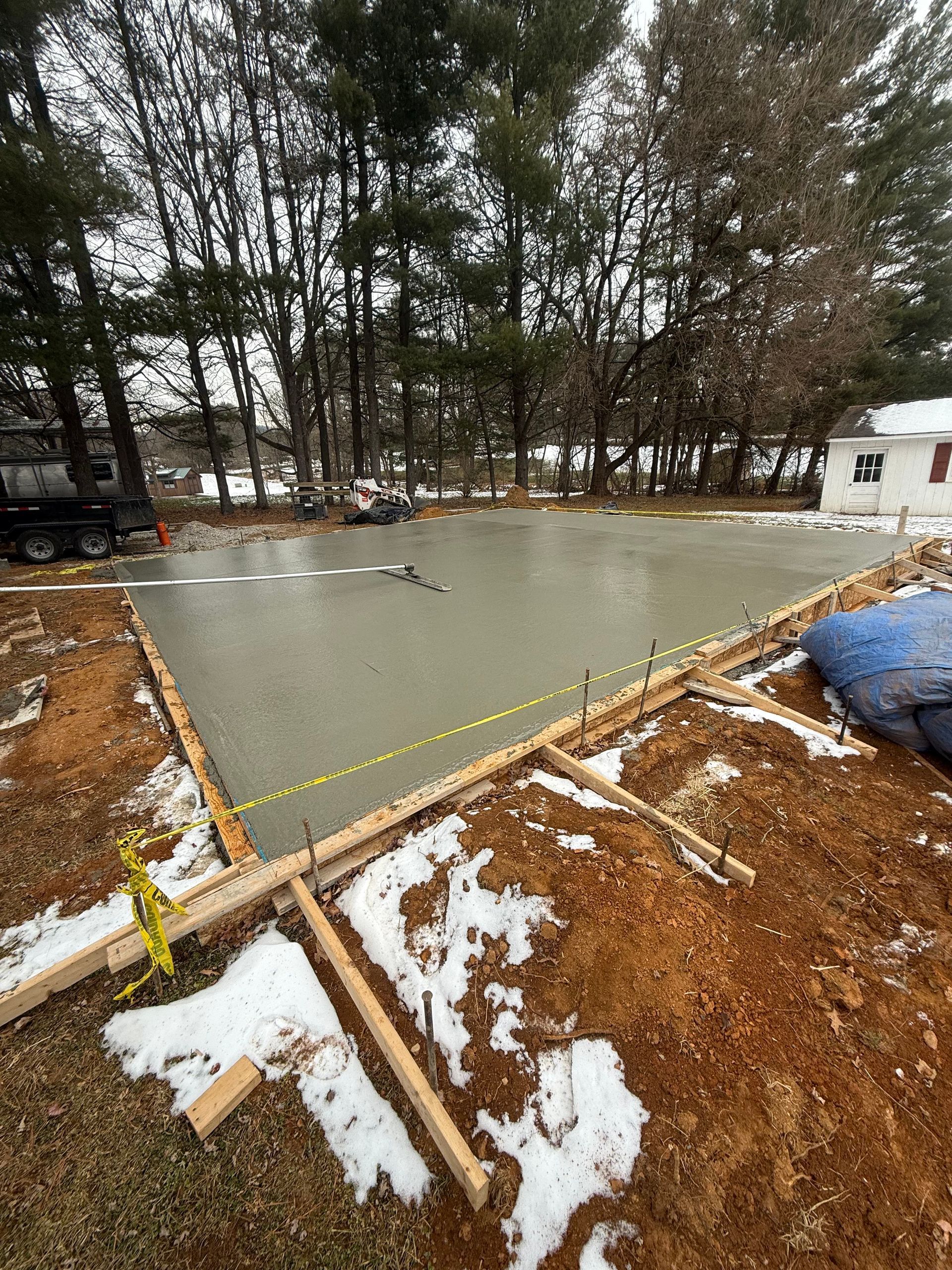 A concrete foundation is being built in a residential area.