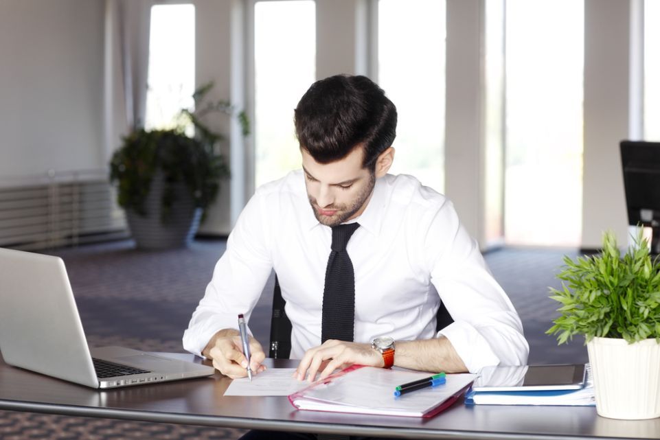 Office Worker Filling Out Paperwork — Northern Accounting Solutions In Brisbane, QLD