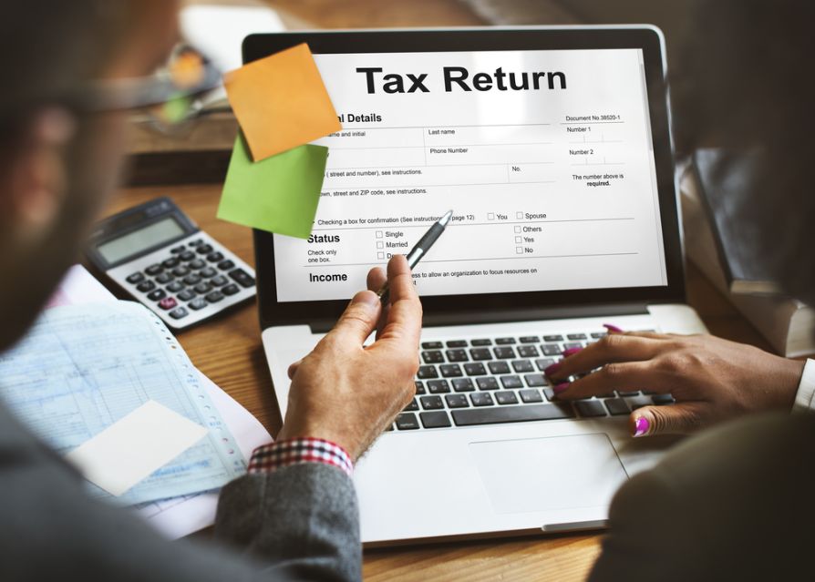 People Using a Laptop to Complete a Tax Return — Northern Accounting Solutions In Brisbane, QLD