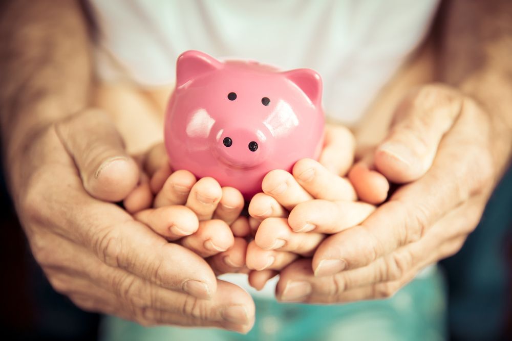 Family Holding a Piggy Bank — Northern Accounting Solutions In Brisbane, QLD