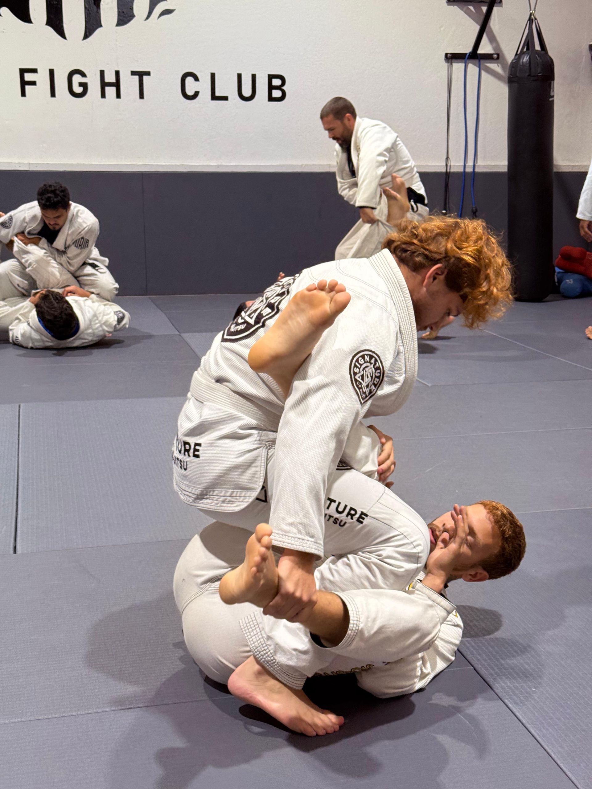 Adult students drilling jiu-jitsu technique at Signature of Jiu-Jitsu in Belmont, CA, building resilience and fitness