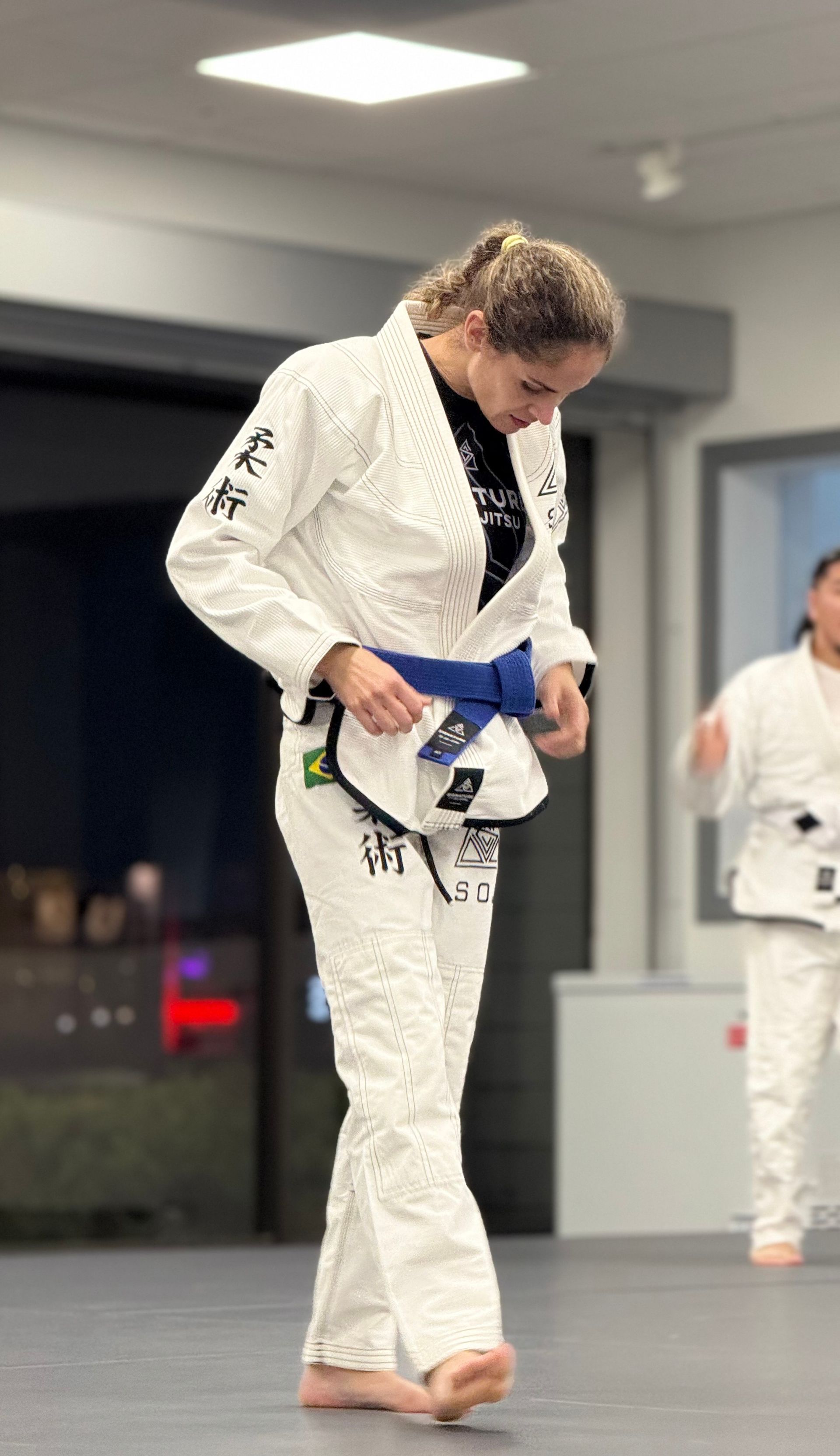 Adults drilling Brazilian Jiu-Jitsu techniques at Signature of Jiu-Jitsu in Belmont, CA for fitness and confidence.