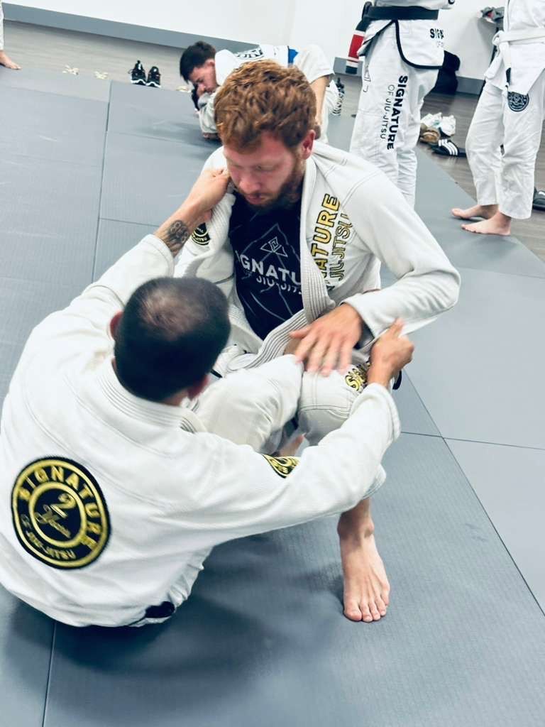 Students train grappling drills at Signature of Jiu-Jitsu in Belmont, CA, building strength.