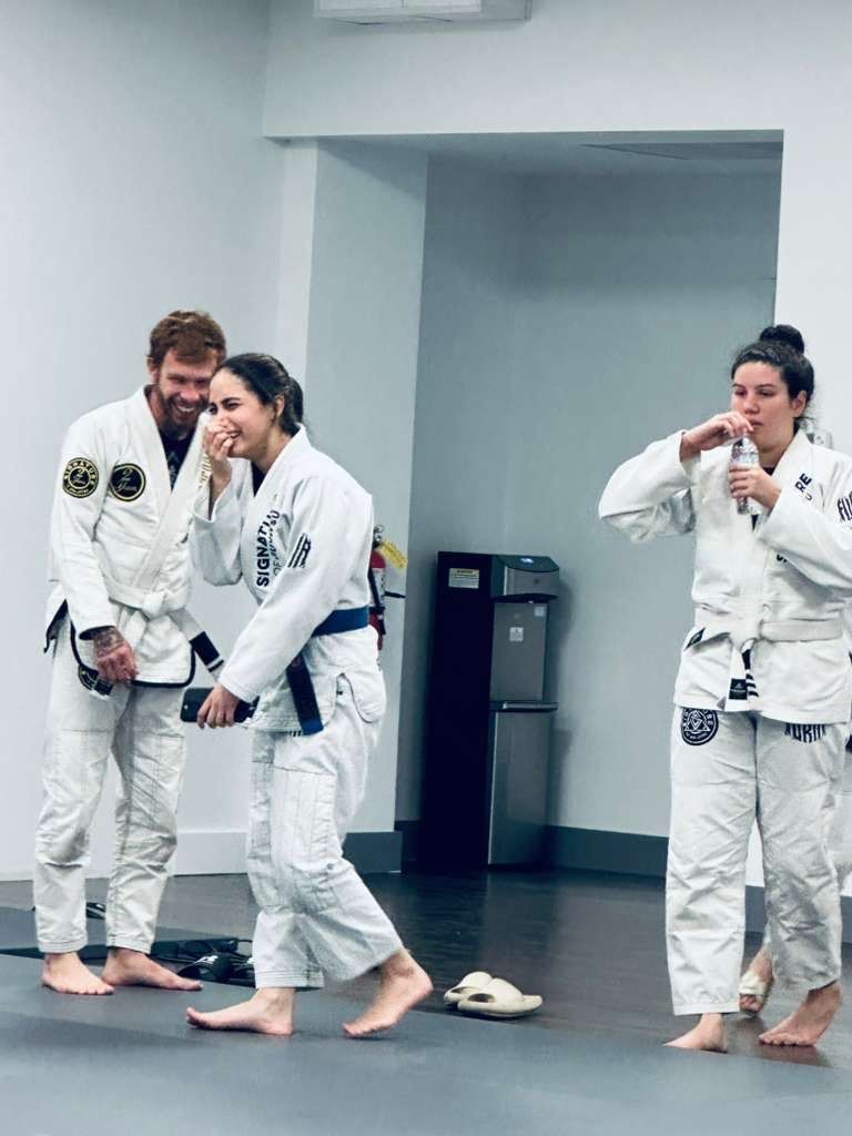 Adults practicing Brazilian Jiu-Jitsu drills at Signature of Jiu-Jitsu in Belmont, CA to build agility and focus.